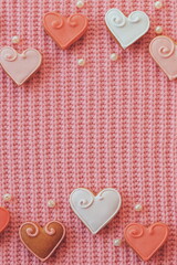 Fototapeta na wymiar Gingerbread hearts on a pink background. Vertical Banner