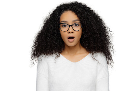 Shocked Woman With Frizzy Hair And Glasses, Isolated On White Background, Surprised And Stunned