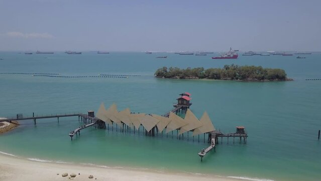 Aerial drone fly over view of Wings Of Time at Siloso Beach Sentosa - Singapore Circa 2022