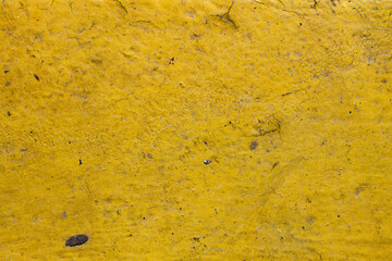yellow concrete. yellow paint. damaged yellow concrete. damaged concrete. cracked material.