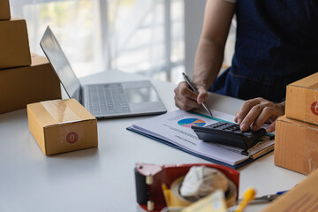 Start a small businessSME ownersEntrepreneurs work boxes and check online orders with laptops to prepare, pack, sell, sell to customers, SME business ideas. 