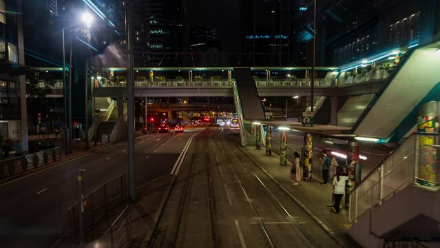 Motion Time lapse View from the front of tram in Hong Kong Moving along the roads in the center of Hong Kong Island. Trams run in Hong Kong's financial district at night and pick up passengers.