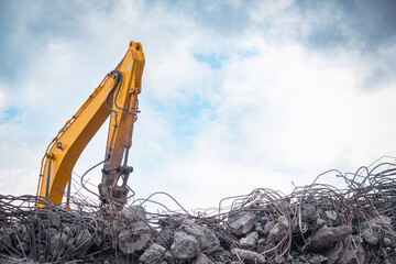 yellow dozer working on building debris. Heavy duty machinery.