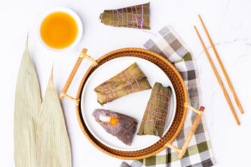 Traditional Chinese food for Dragon boat festival. Closeup zongzi or sticky rice dumpling on white...