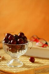Cherry. a light snack with cherry berries and reading a book. a vase of berries on a tray in bed.
