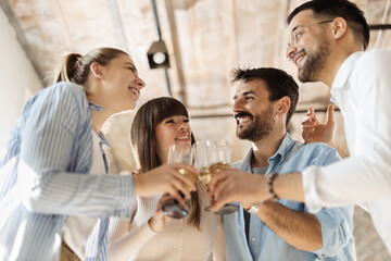 Group of happy business people toasting with wine at office party