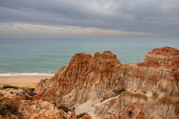 Fototapeta na wymiar Praia da Falesia, Albufeira, Algarve, Portugal.A huge beach of almost 6 km in length flanked by stunning red and golden cliffs with spectacular formations, reminiscent of hoodoos