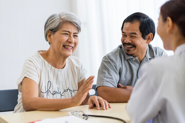Asian seniors who are healthy, in a good mood, smiling, talking with financial or life insurance...