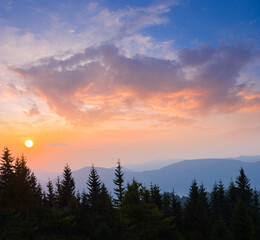 sunrise above mountain forest silhouette,  early morning mountain scene