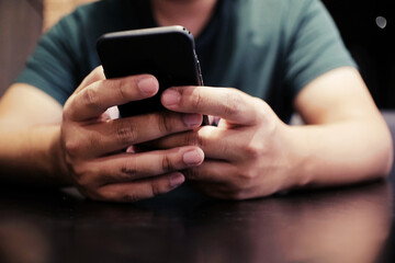 Cropped view of male hands holding cell phone with blank screen.Man using electronic gadget, typing message or checking newsfeed on social networks.
