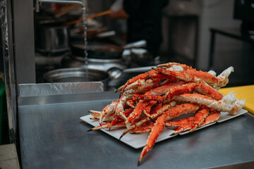 Legs of fresh red Kamchatka crab on the table in the restaurant kitchen. Freshly frozen crab meat for cooking