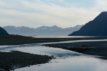 River leading to the sea at low tide in northern Norway