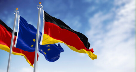 Germany and EU flags waving in the wind on a clear day