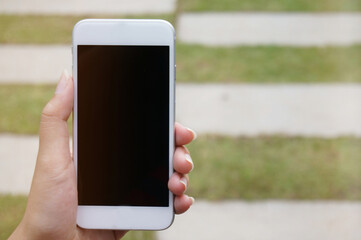 Close up of women's hands holding cell telephone blank copy space screen. smart phone with technology concept.