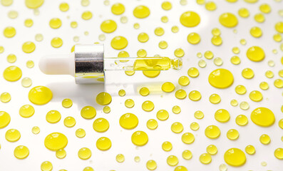 Drops of oil pipette isolate on white background. Selective focus.