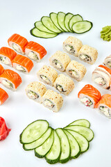 Traditional delicious fresh sushi set Philadelphia roll with salmon, smoked eel and cucumber isolated on white background. Sushi menu. Japanese asian food