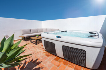 On the terrace of the house there is a modern outdoor Jacuzzi tub for tourists to relax. sunny day