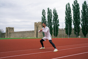 Fototapeta premium Man Warming Up and Stretching Before Workout and Running