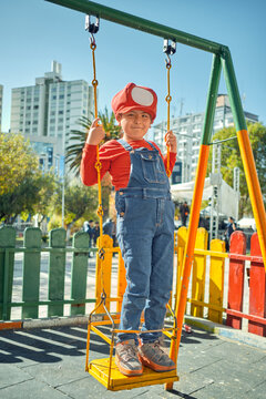 latin boy playing in an outdoor park with mario bros clothes in the city of la paz bolivia