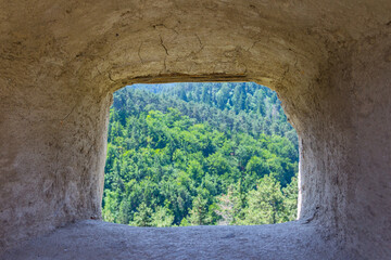 A view of the forest through the window in the Rasnov Citadel. Transylvania. Romania