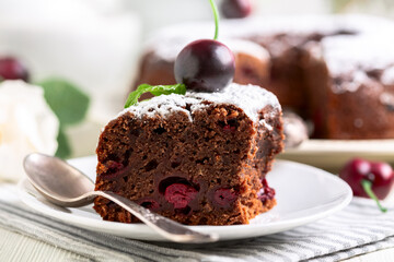 Piece of chocolate pie with cherries.