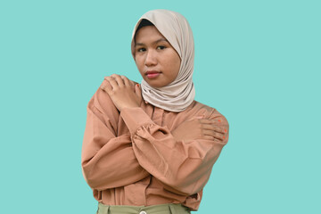 Young beautiful Asian Muslim woman wearing a headscarf hugging herself on white background. happy and positive, smiling confident. Self-love and self-care	