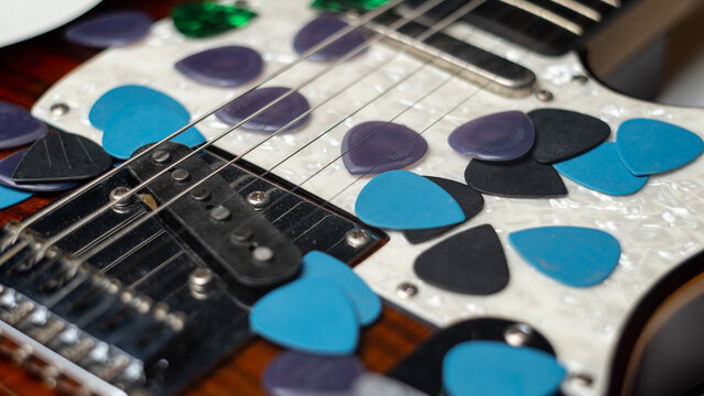 Guitar Picks Scattered on Guitar Body