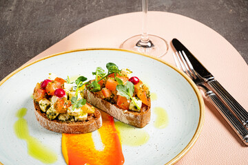 Italian bruschetta with roasted tomatoes, mozzarella cheese and herbs