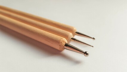 Three dots for nail art on a white table, close-up.