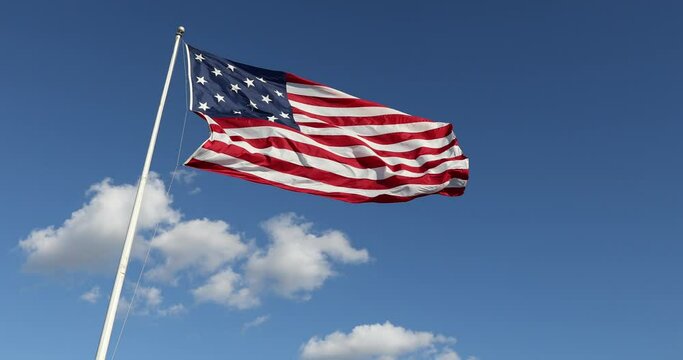 Waving USA Flag in Clear Blue Sky. USA American Flag. Waving United States of America Famous Flag. Sunny Day.