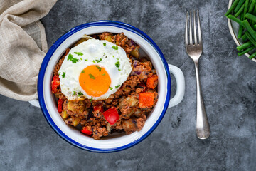 Corned beef hash with fried egg and green beans