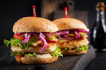 Chicken hamburger. Sandwich with chicken burger, tomatoes, cheese and lettuce. Cheeseburger.