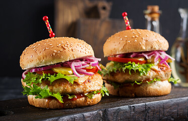 Chicken hamburger. Sandwich with chicken burger, tomatoes, cheese and lettuce. Cheeseburger.