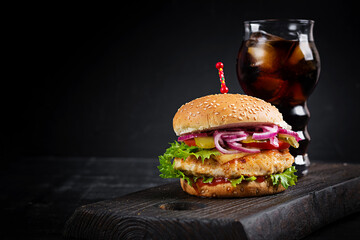 Chicken hamburger. Sandwich with chicken burger, tomatoes, cheese and lettuce. Cheeseburger.