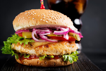 Chicken hamburger. Sandwich with chicken burger, tomatoes, cheese and lettuce. Cheeseburger.