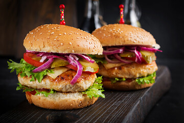 Chicken hamburger. Sandwich with chicken burger, tomatoes, cheese and lettuce. Cheeseburger.