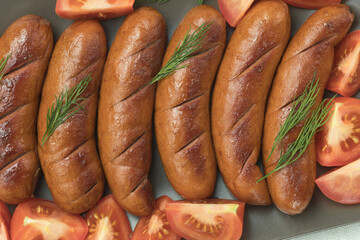 Grilled meat sausages. Fried sausage. Fried anchovies preparing for consumption.