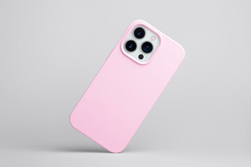 iPhone 13 Pro in pink soft silicone case falls down back view, phone case mockup isolated on grey...