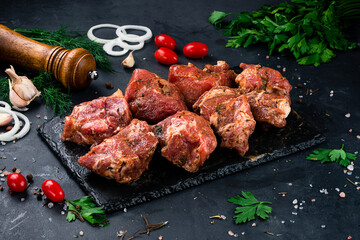 Marinated beef for barbecue with onion, tomatoes, sauce and spices.