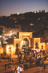 Arabic square Rcif in Fes in Morocco at night. People in market and street food.  