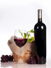 Glass of red wine, bottle and grapes isolated. Alcohol drinks, vine and wineglass on white clean background. Generative AI