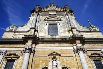 Alte Fassade mit Verzierungen, Ornament und Giebel in Beige und Naturfarben im Sonnenschein als...