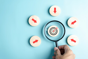Magnifier glass focus to target icon with arrow to planning and management business development...
