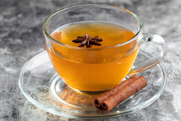 Anise tea with cinnamon in glass cup.