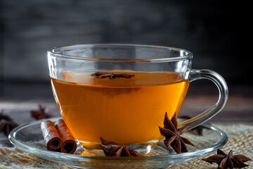 Anise tea with cinnamon in glass cup.