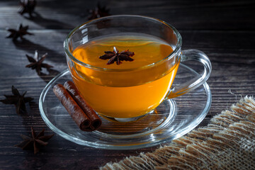 Anise tea with cinnamon in glass cup.