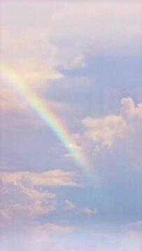 Vertical video Rainbow in cloudy sky timelapse loop, seamless looping animated background motion backdrop sky and clouds, beautiful weather