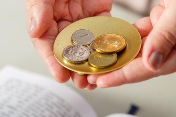 A Jewish woman performs pre-wedding rituals with silver shekels for a secure life.