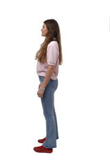 side view of a young girl standing on white background