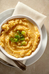 Root mash. Root vegetables mashed in a bowl. Garnished with oil and herbs.